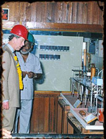 His Royal Highness, Prince of Wales, Prince Charles views a model of the EHP still. This still is the only operational wooden still of its kind in the world today. DDL continues to utilize this still in its production process.